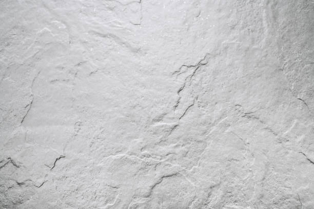 White abstract background with detailed stone texture.