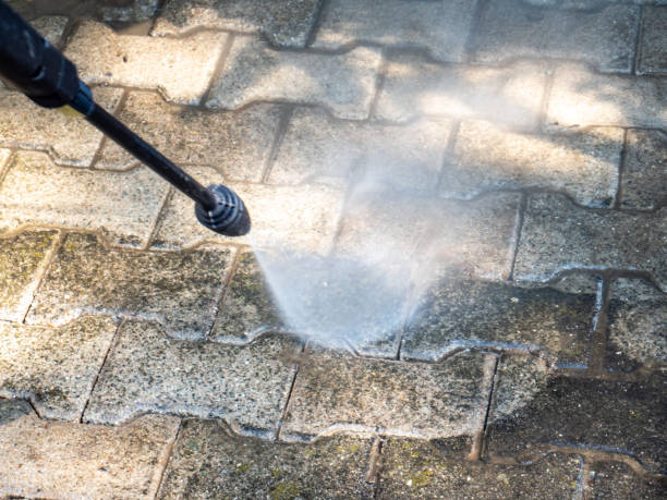 old cleaning the terrace with high pressure cleaner.