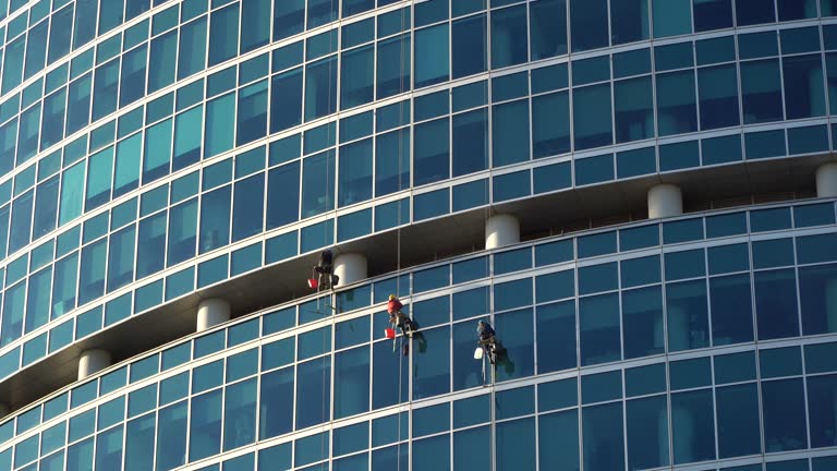 The window washers on the skyscraapers at work,