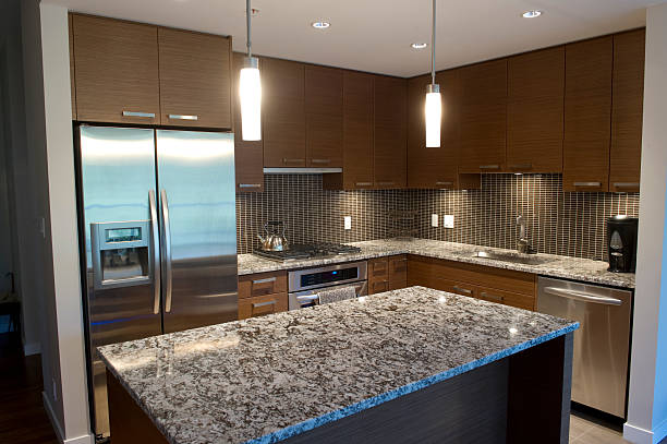 Modern luxury kitchen featuring granite counter tops and stainless steel appliances.