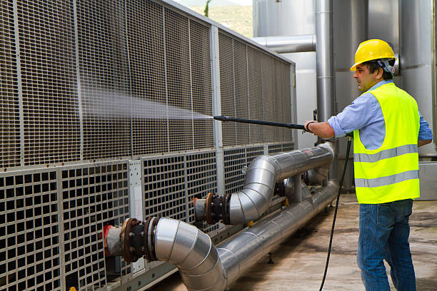 man washing around the industrial site