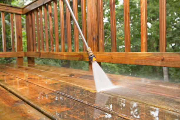 A pressure washer sprayer is cleaning a patio.