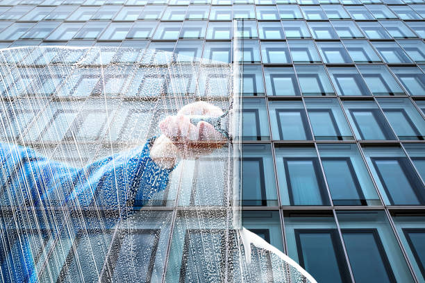 Window cleaner works on the office high-rise facade - symbolically